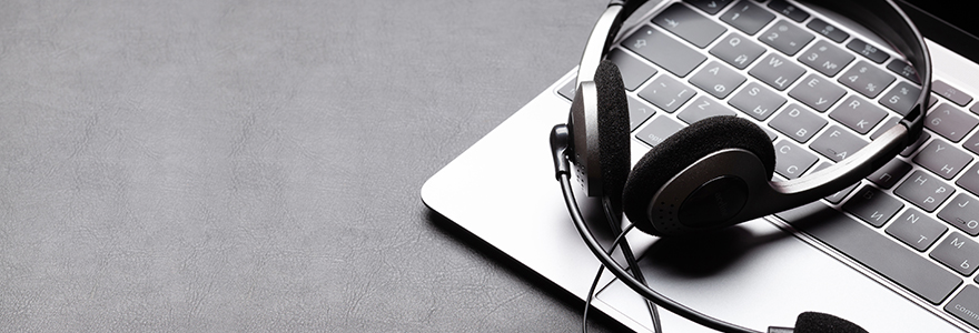 Photograph of office desk with headset and laptop